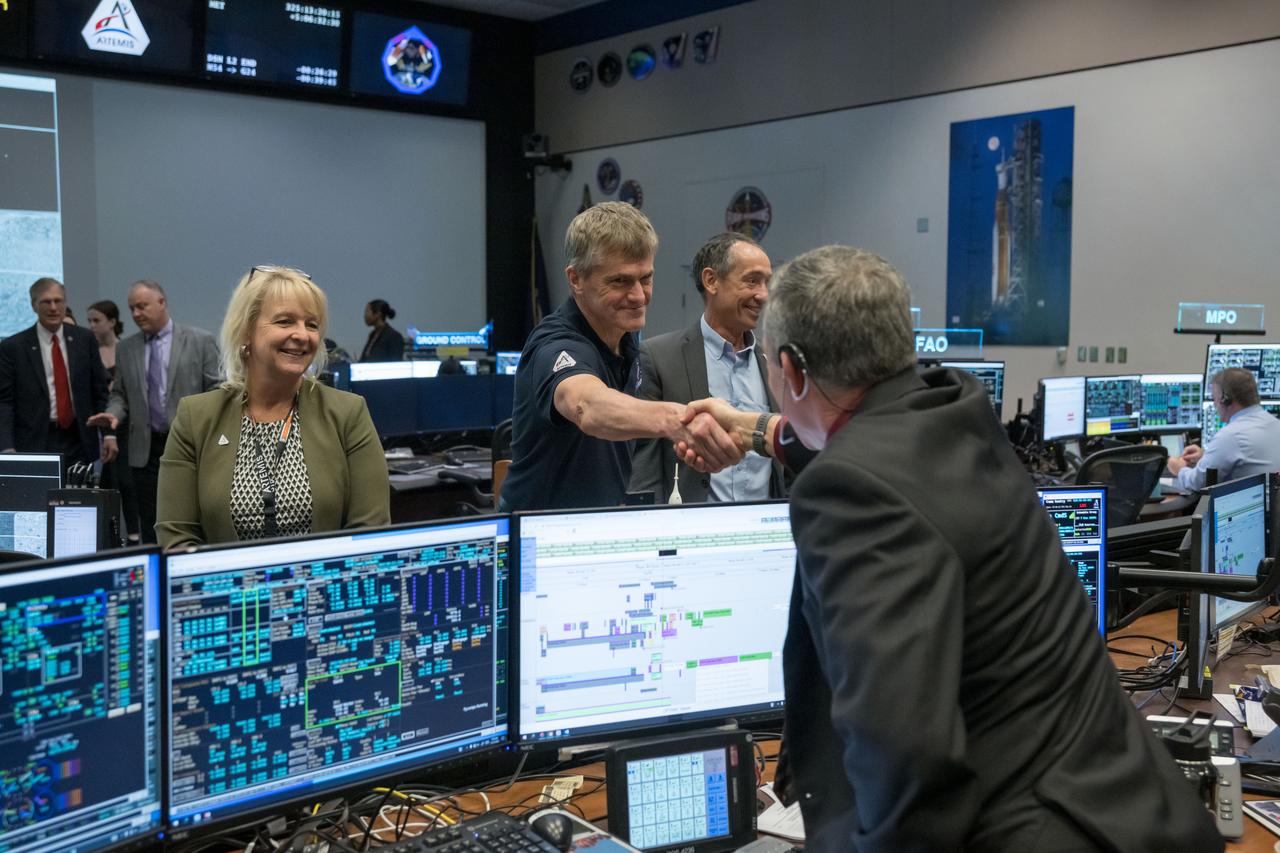 jsc2022e089183 (Nov. 21, 2022) During flight day 6 of the 25.5-day mission, Orion program managers greet Artemis I Lead Flight Director Rick LaBrode in the White Flight Control Room at the Johnson Space Center in Houston. The visit followed during the Outbound Powered Flyby (OPF) burn, which set Orion on a course to fly by the Moon at a closest distance of 81 miles (130.5 kilometers).